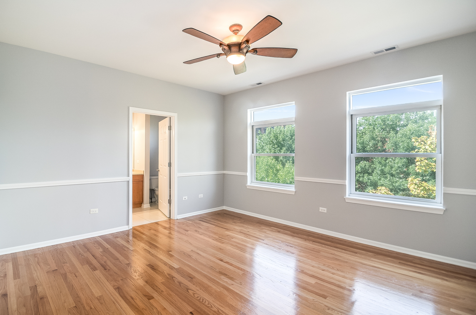 1461 South Halsted Street, Unit 3B Chicago, IL 60607 - Photo 9 of 21 a view of an empty room with window and a kitchen