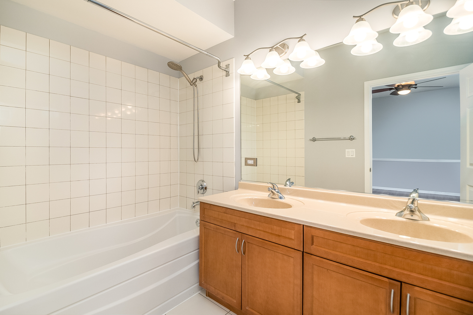 1461 South Halsted Street, Unit 3B Chicago, IL 60607 - Photo 10 of 21 a bathroom with a sink a mirror a bathtub and a shower