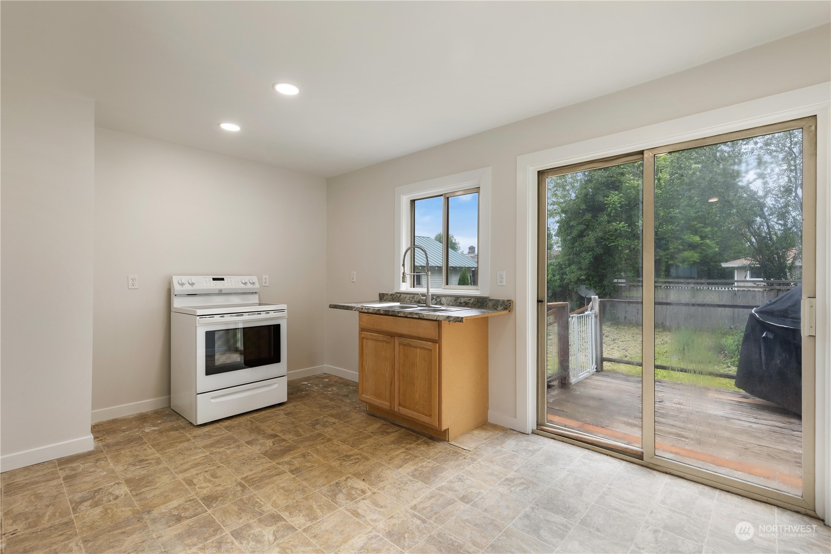 705 Main Street Sultan, WA 98294 - Photo 11 of 31 a kitchen with a stove top oven and sink