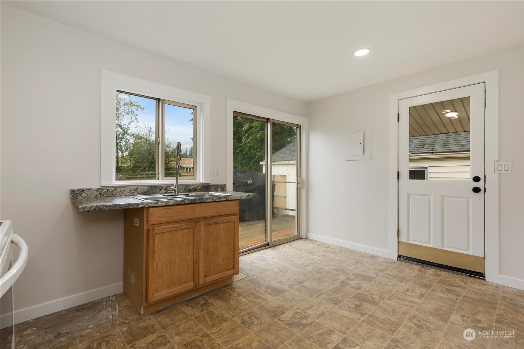 705 Main Street Sultan, WA 98294 - Photo 12 of 31 a kitchen with granite countertop a sink and a refrigerator