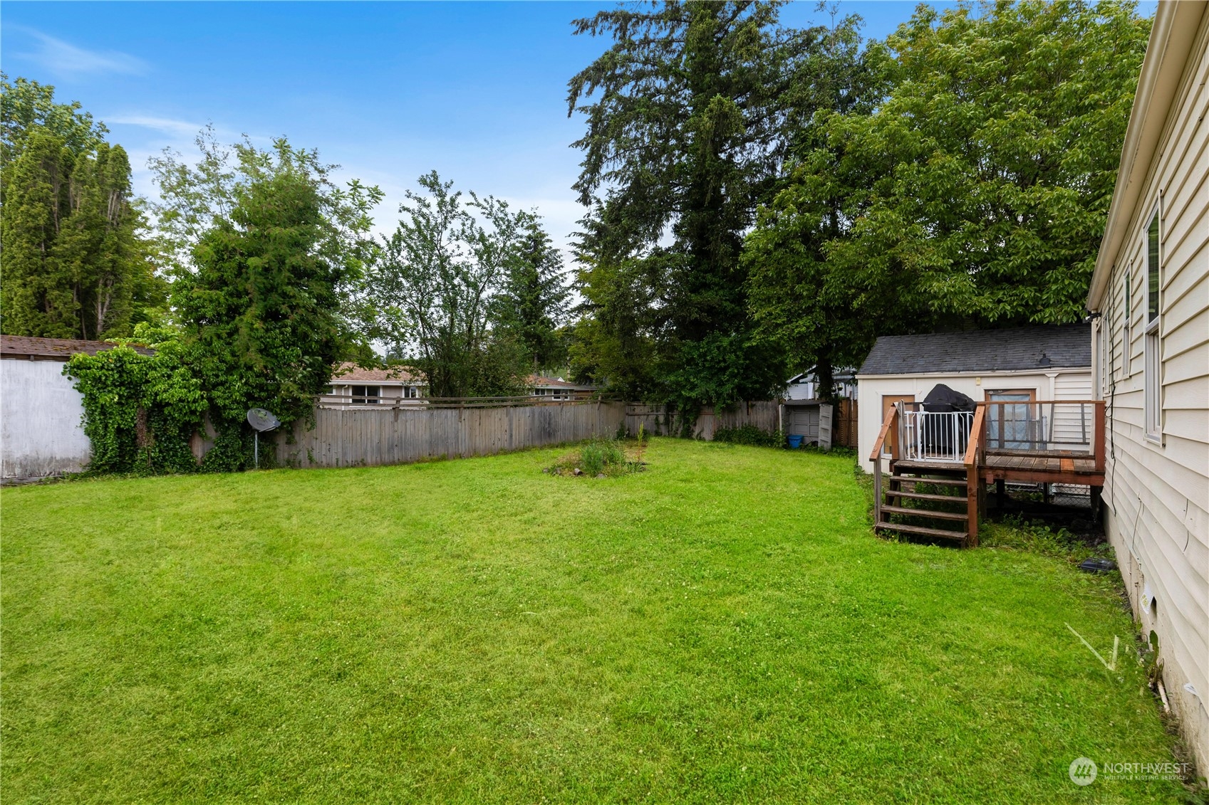 705 Main Street Sultan, WA 98294 - Photo 20 of 31 a backyard of a house with a garden and barbeque oven