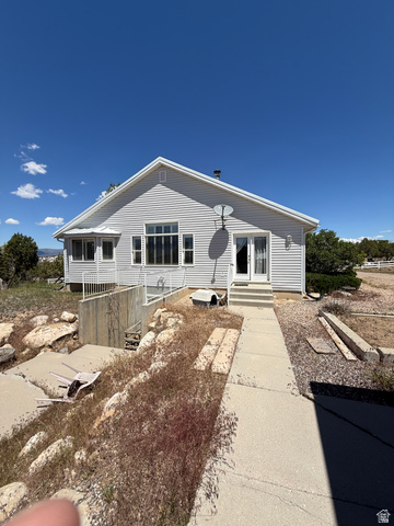 10000 North 6730th East Spring City, UT 84662 - Photo 22 of 31 Light gray siding exterior with a gable roofline
