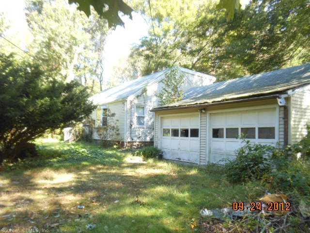a view of house with a yard
