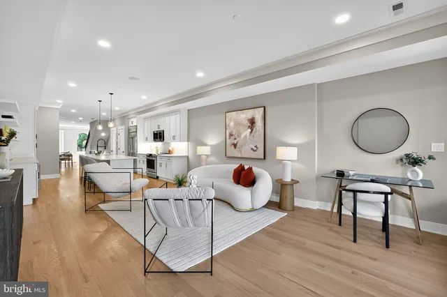 a view of a a dining room with furniture window and wooden floor