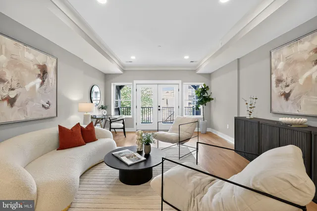 a living room with furniture and a dining table