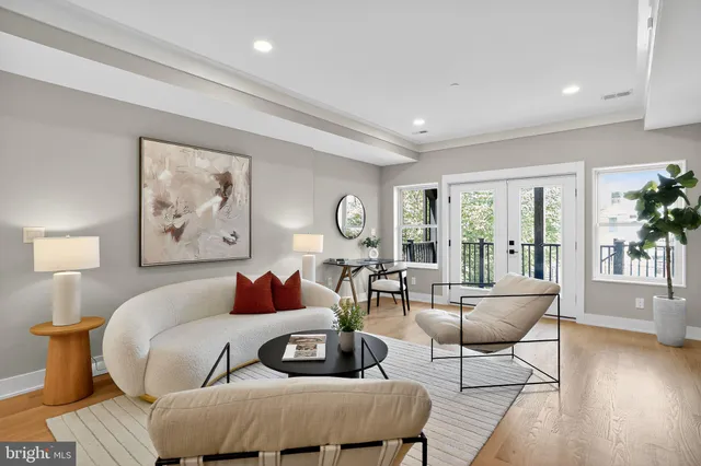 a view of a room with wooden floor and a floor to ceiling window