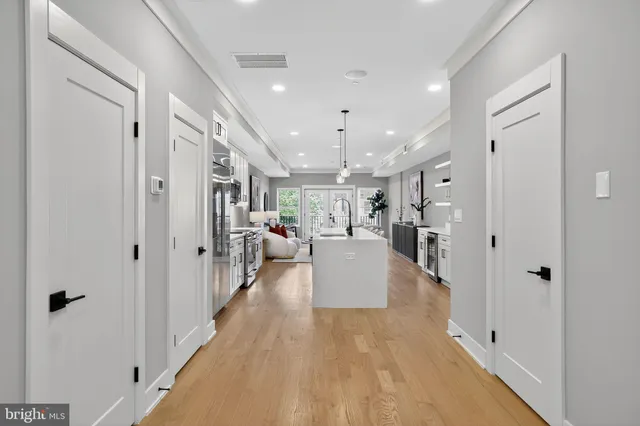 a kitchen with white cabinets and white appliances