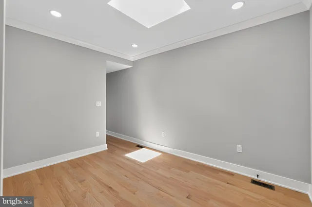 a bathroom with a toilet a sink a mirror and vanity