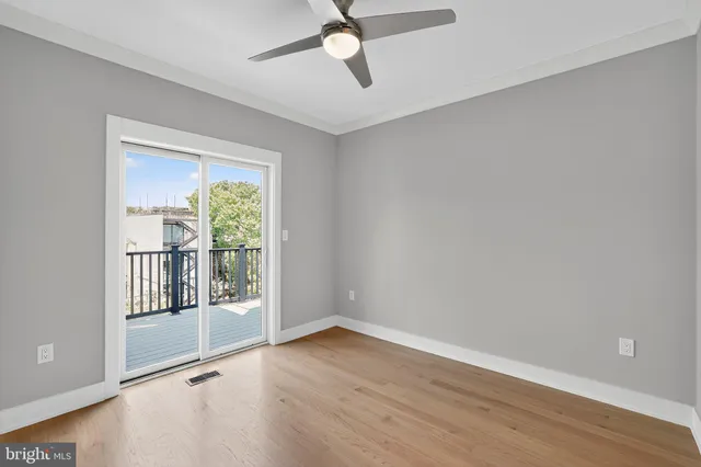 a view of a porch with wooden floor and floor to ceiling window