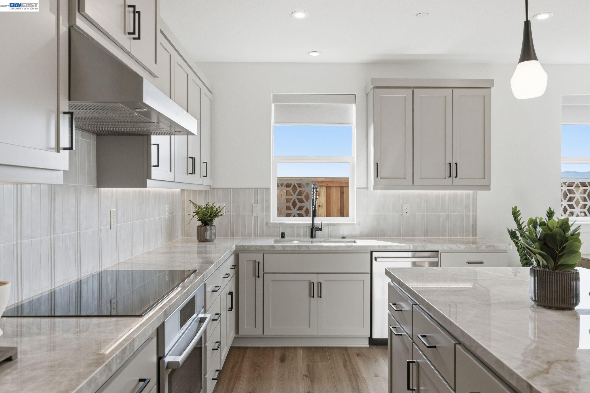 3952 Viggo Way Dublin, CA 94568 - Photo 18 of 39 a kitchen with a sink dishwasher a stove and cabinets