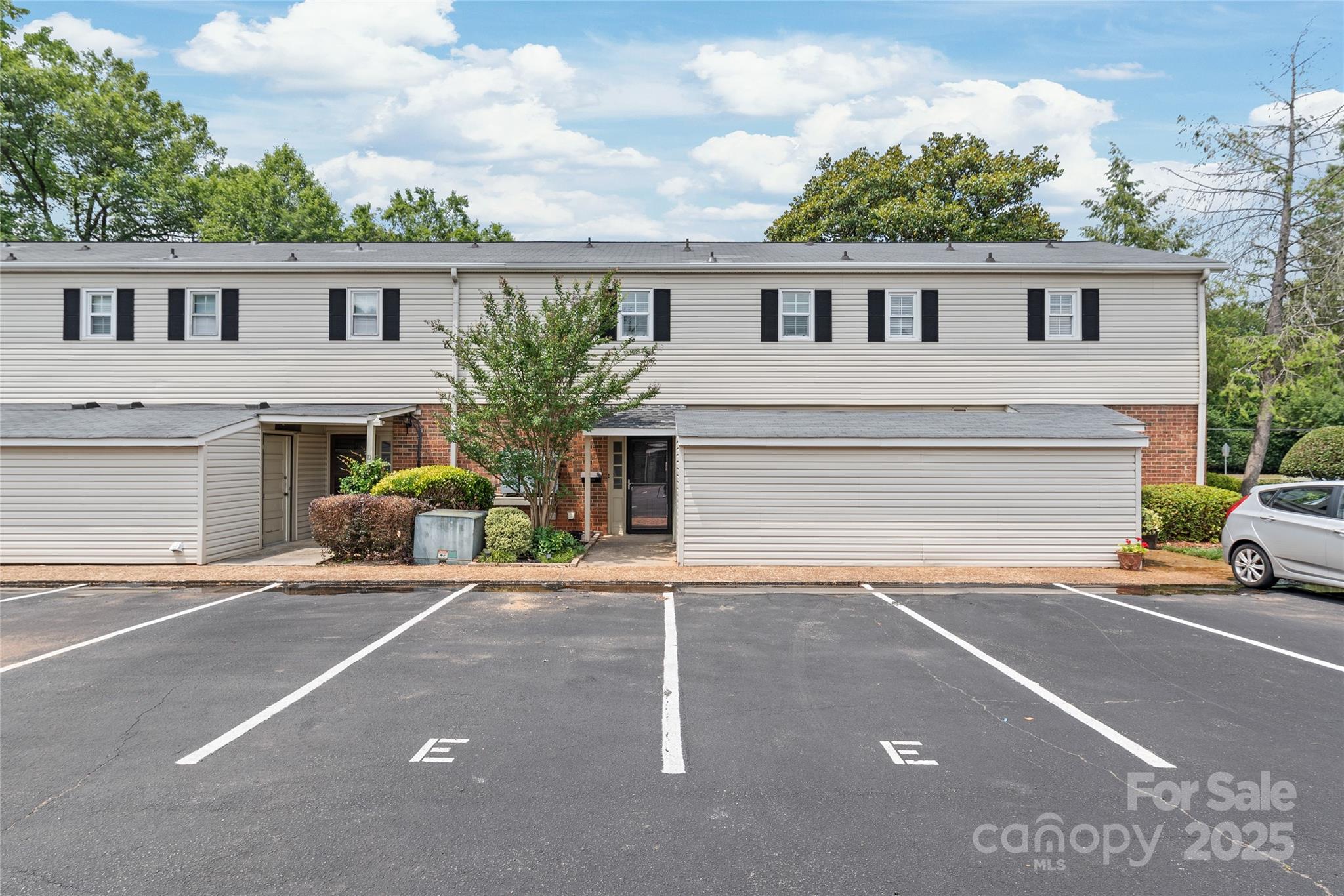a view of a house with a patio and a yard