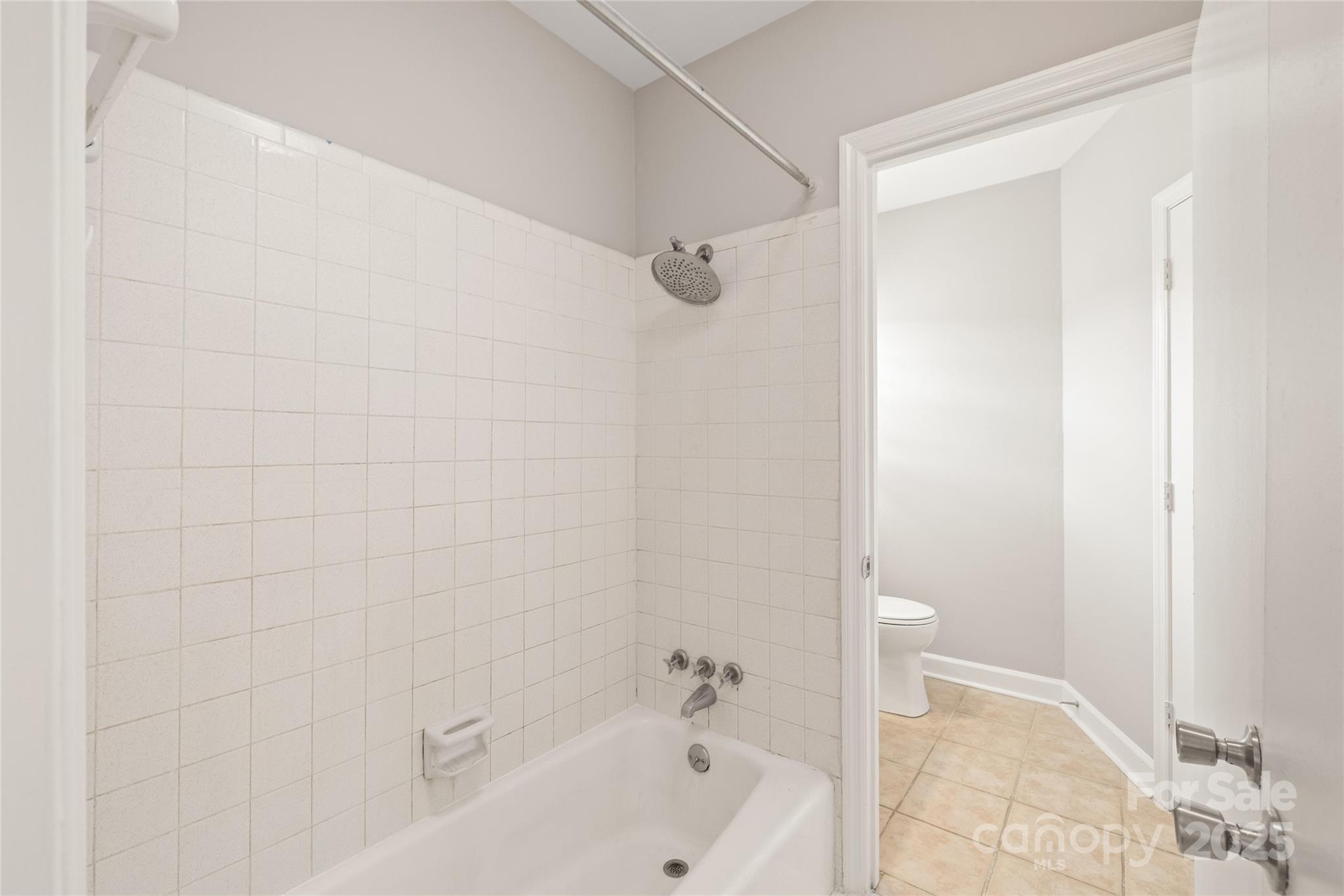 5949 Quail Hollow Road, Unit E Charlotte, NC 28210 - Photo 21 of 27 a bathroom with a bathtub and shower