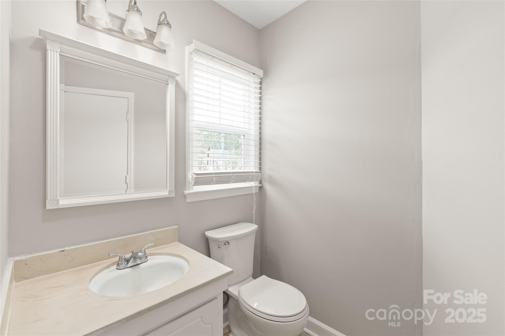 5949 Quail Hollow Road, Unit E Charlotte, NC 28210 - Photo 22 of 27 a bathroom with a sink a toilet and a window