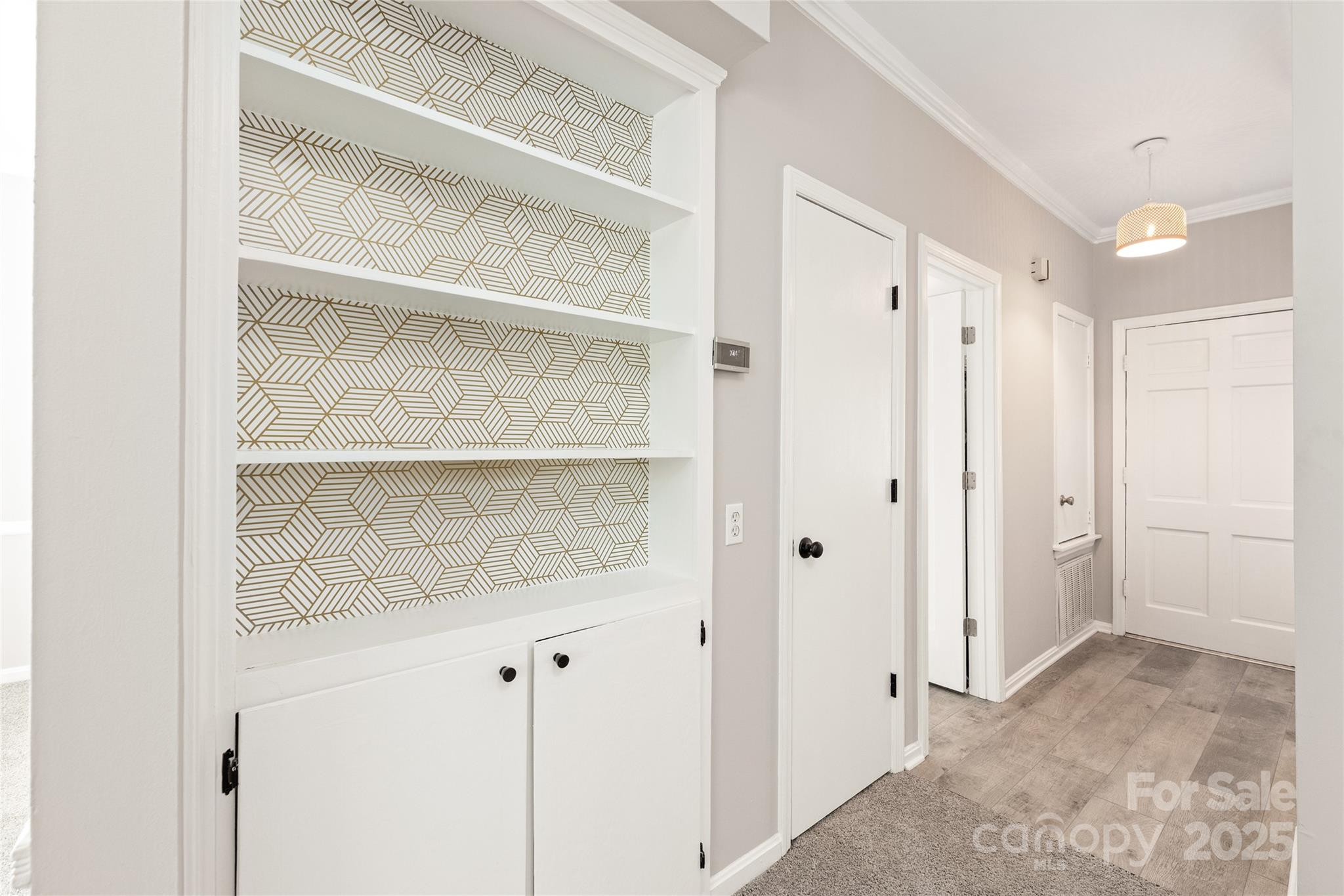 5949 Quail Hollow Road, Unit E Charlotte, NC 28210 - Photo 7 of 27 a view of a room with wooden floor and cabinet