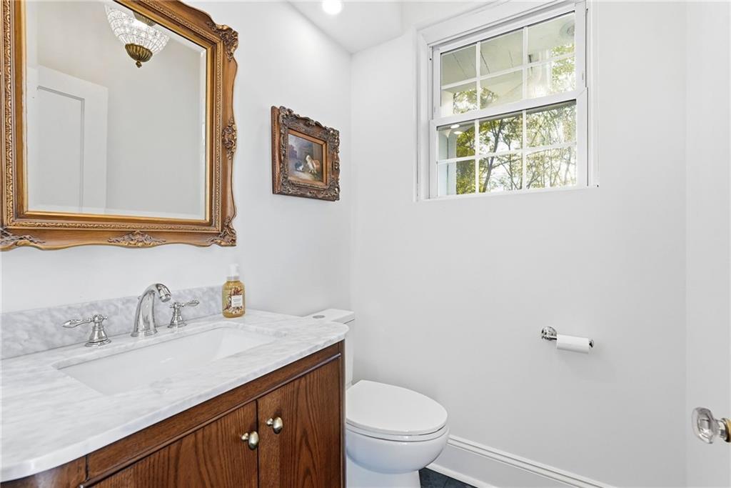 3944 Bakerstown Road Gibsonia, PA 15044 - Photo 31 of 50 a bathroom with a toilet a sink a mirror and a window
