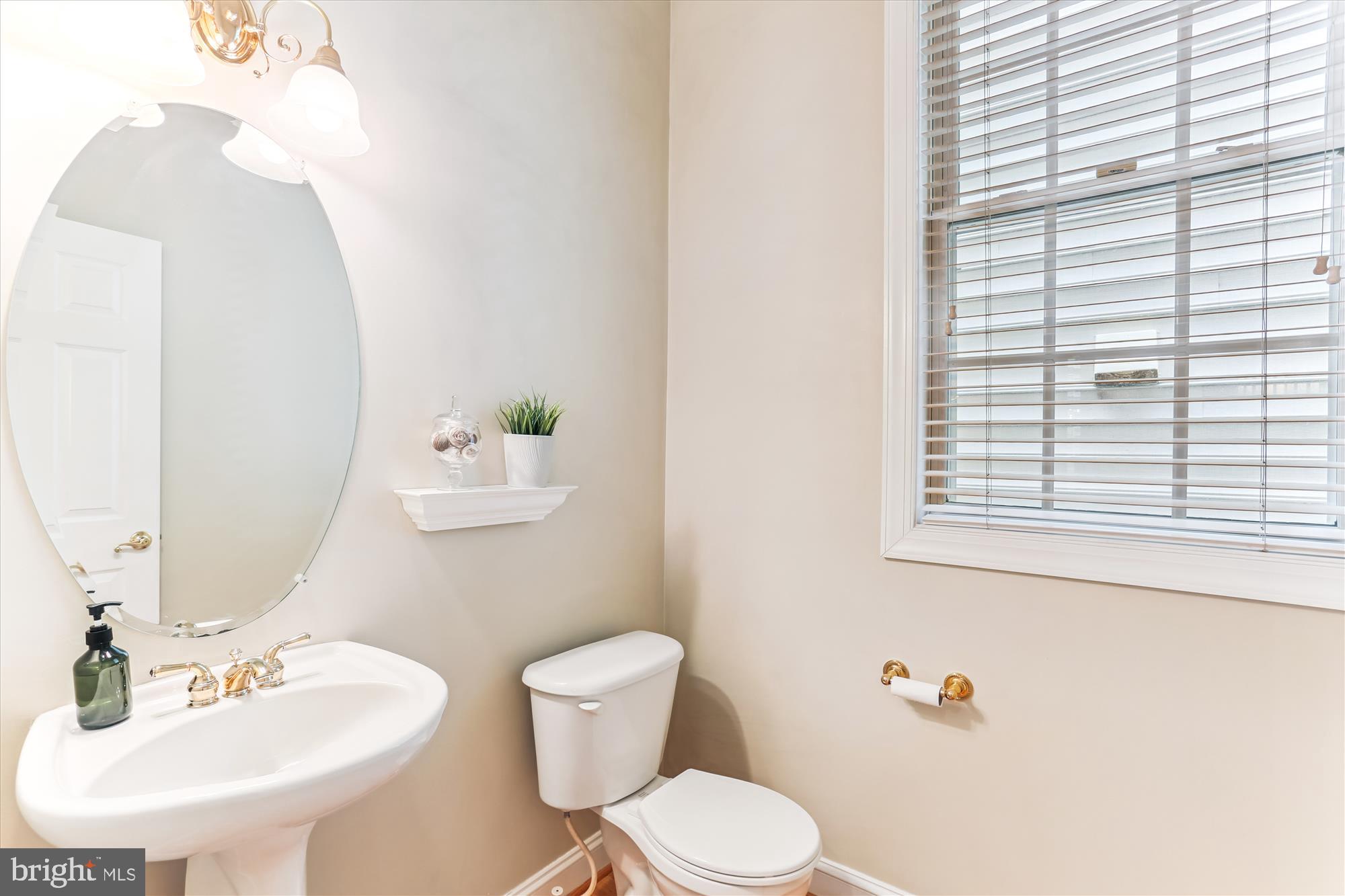 713 Bright Meadow Drive Gaithersburg, MD 20878 - Photo 20 of 54 a bathroom with a toilet sink and mirror