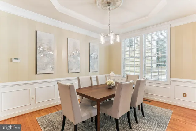 a view of a dining room with furniture wooden floor and chandelier
