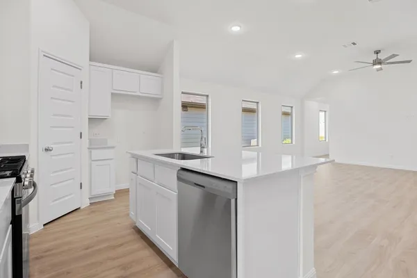 a view of a kitchen with a sink and a refrigerator