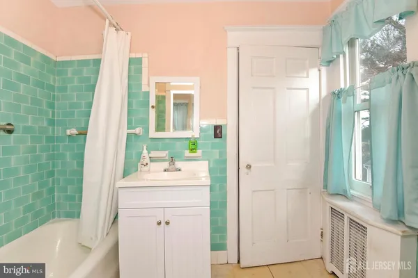 a bathroom with a sink vanity granite tub and shower