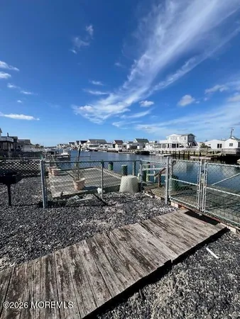 a view of a roof deck with wooden floor and city view