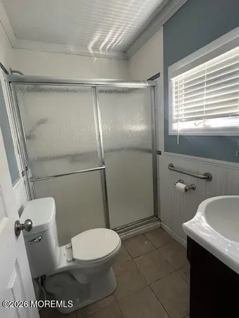 a white toilet sitting next to a bathroom sink
