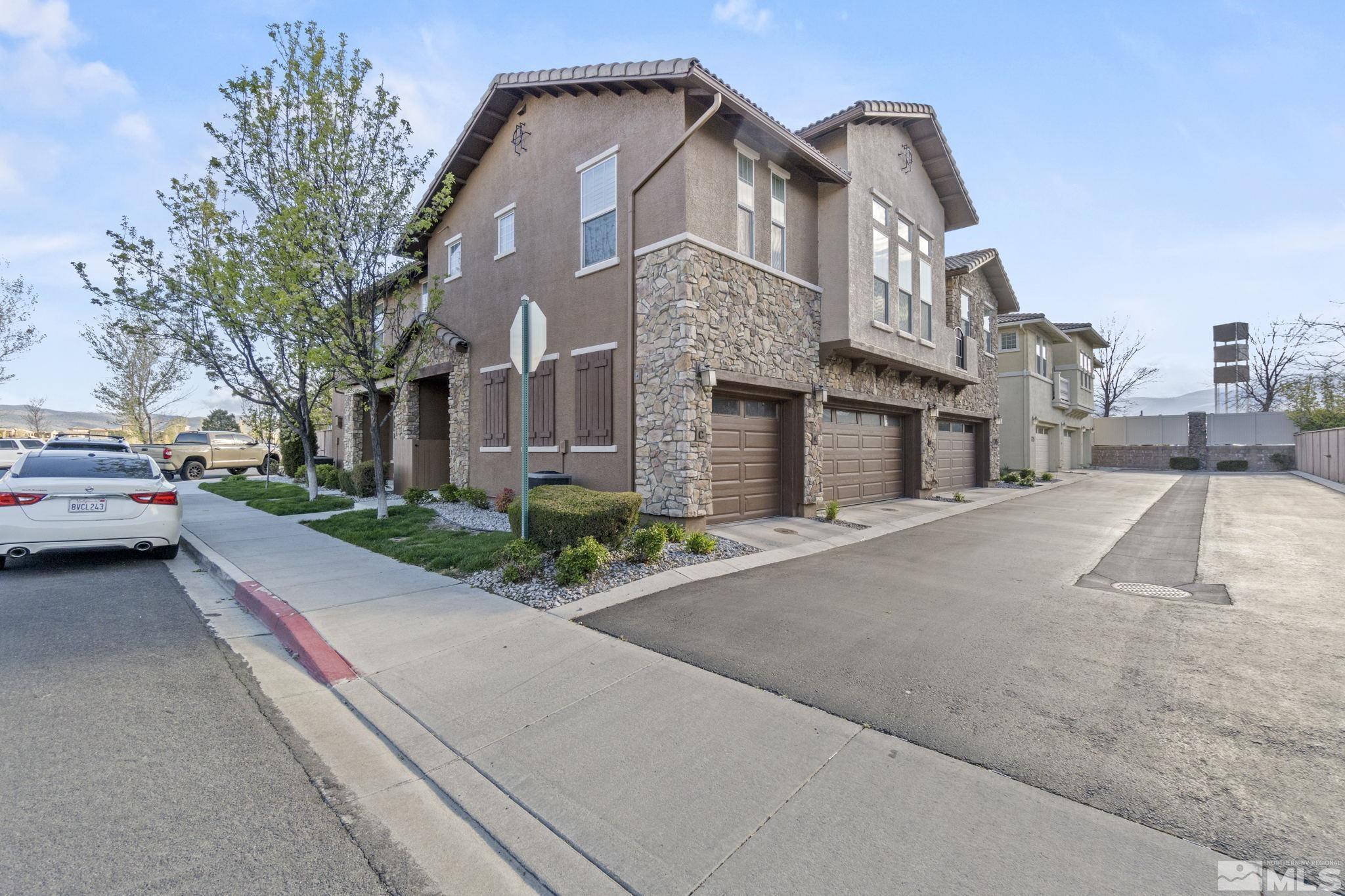 1705 Wind Ranch Road, Unit C Reno, NV 89521 - Photo 1 of 26 a house with a yard and parking space