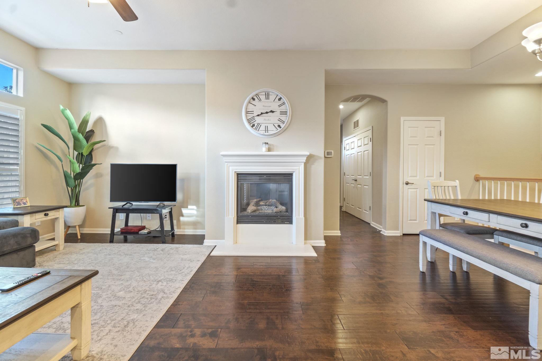1705 Wind Ranch Road, Unit C Reno, NV 89521 - Photo 12 of 26 a living room with furniture a flat screen tv and a fireplace