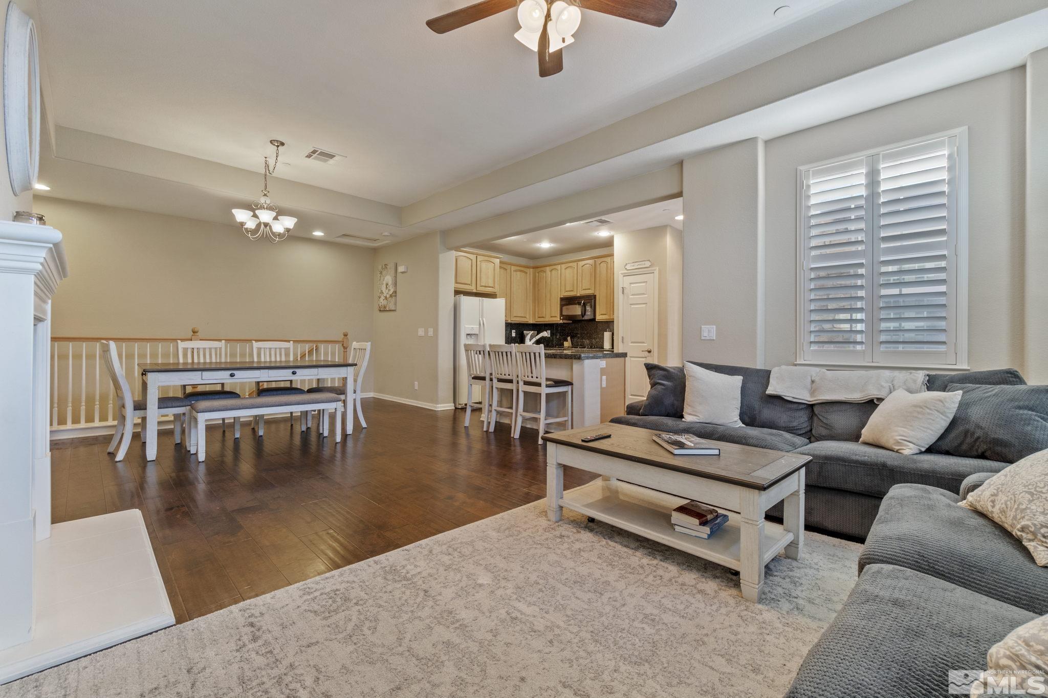 1705 Wind Ranch Road, Unit C Reno, NV 89521 - Photo 14 of 26 a living room with furniture a dining table and a fireplace