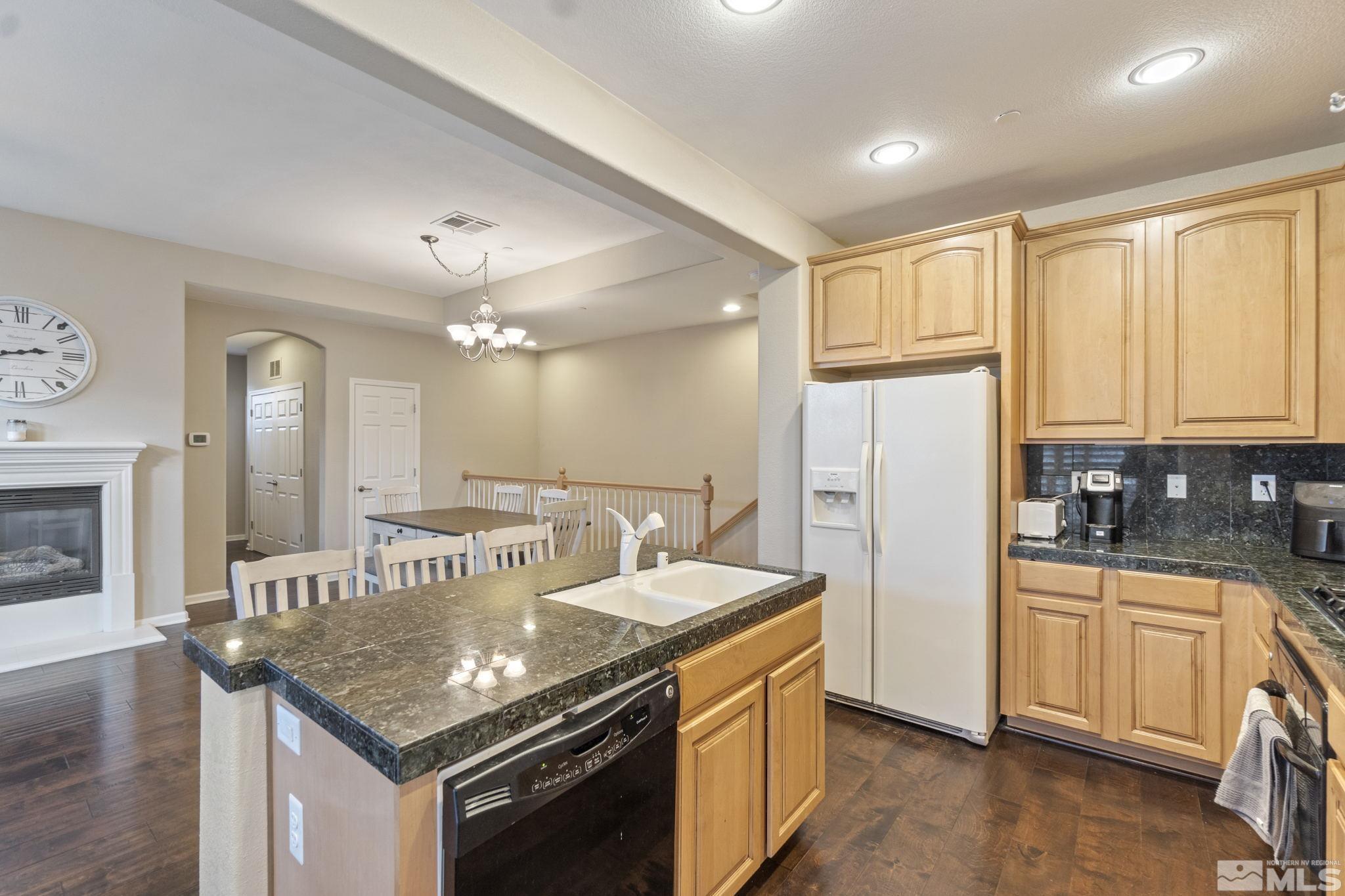 1705 Wind Ranch Road, Unit C Reno, NV 89521 - Photo 19 of 26 a kitchen with granite countertop a sink stove and refrigerator