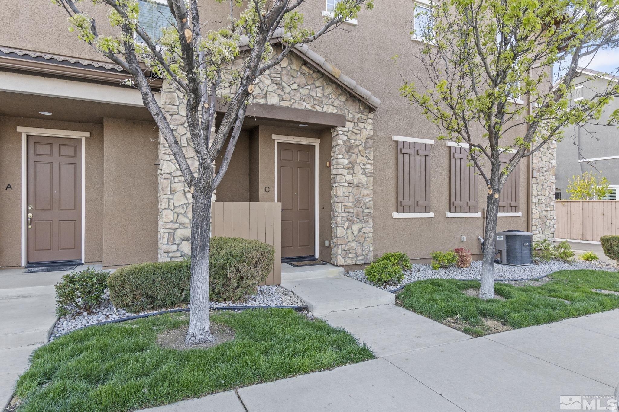 1705 Wind Ranch Road, Unit C Reno, NV 89521 - Photo 2 of 26 a front view of a house with a yard