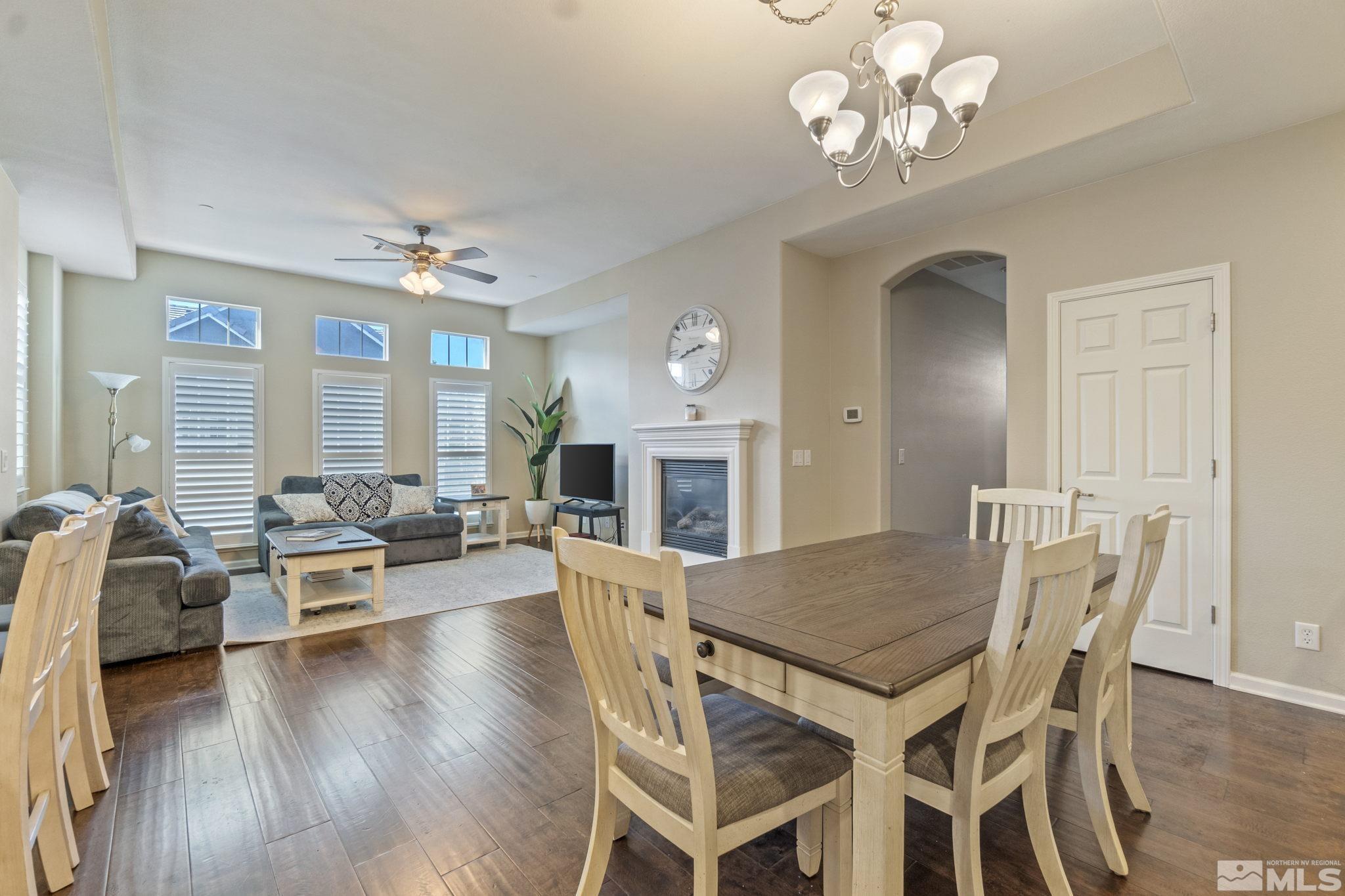 1705 Wind Ranch Road, Unit C Reno, NV 89521 - Photo 6 of 26 a view of a dining room with furniture wooden floor and chandelier
