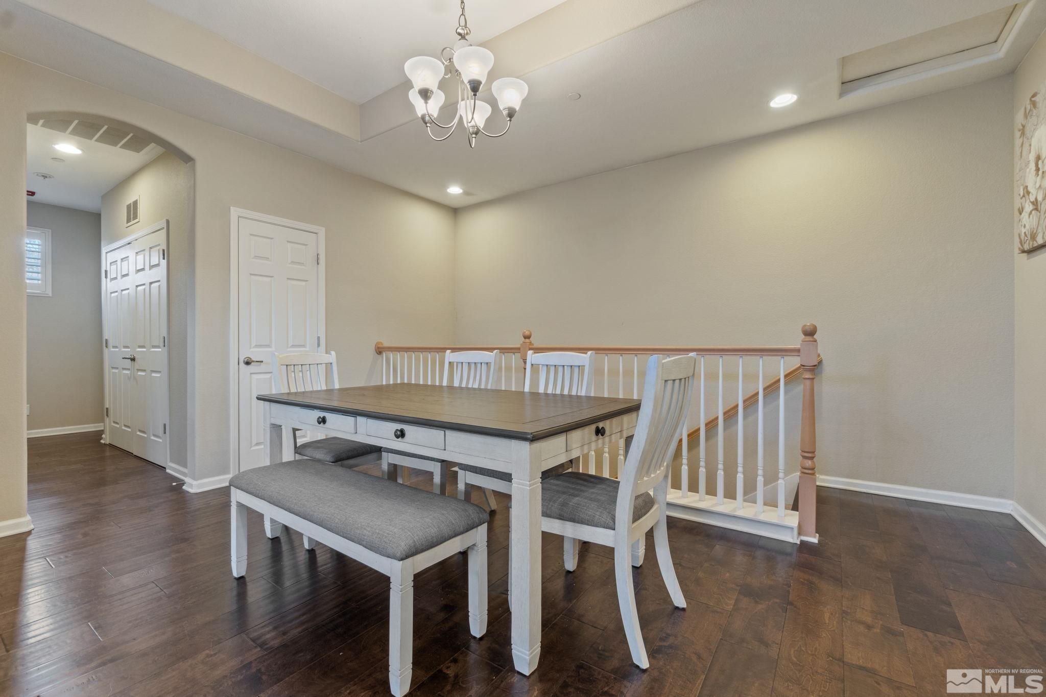 1705 Wind Ranch Road, Unit C Reno, NV 89521 - Photo 7 of 26 a view of a dining room with furniture and wooden floor