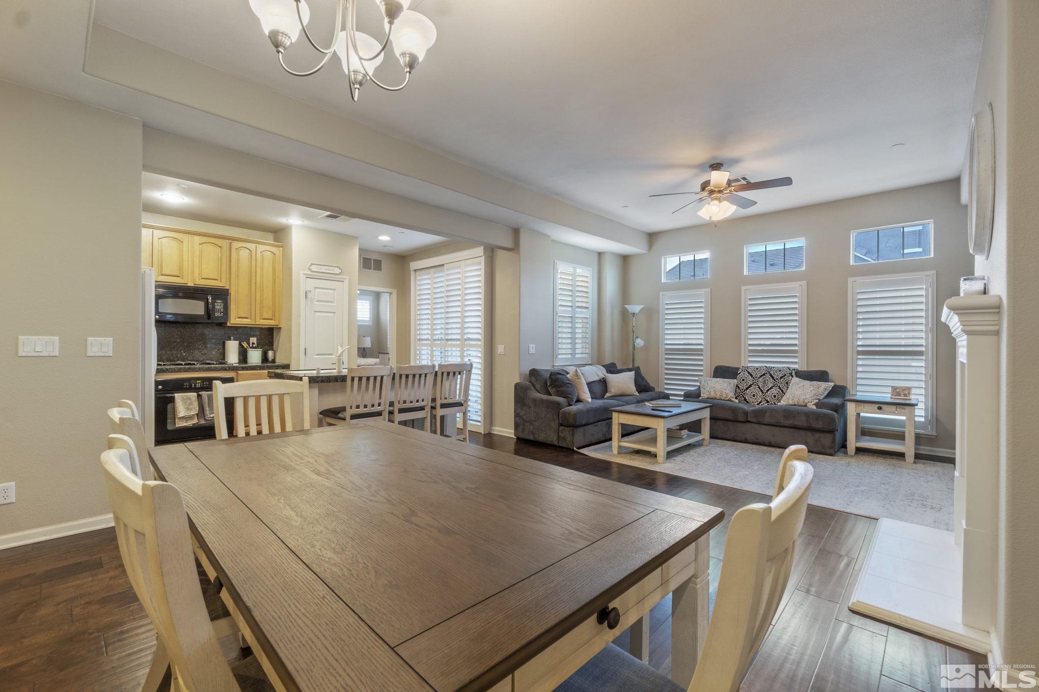 1705 Wind Ranch Road, Unit C Reno, NV 89521 - Photo 9 of 26 a living room with furniture a chandelier and a dining table