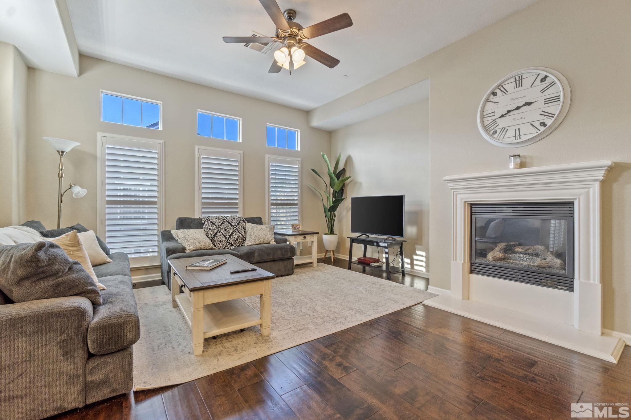 1705 Wind Ranch Road, Unit C Reno, NV 89521 - Photo 10 of 26 a living room with furniture a wooden floor and a large window