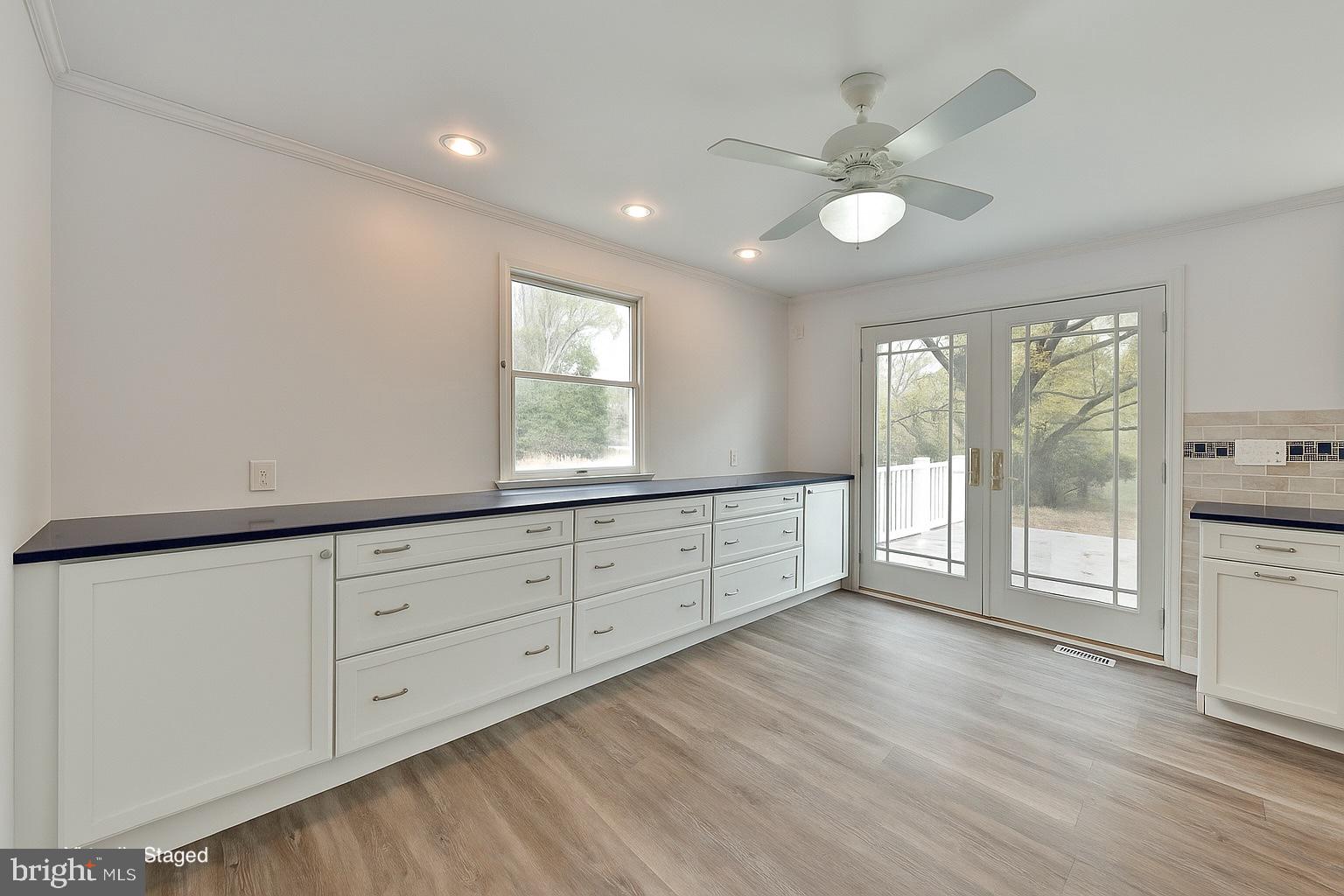 312 East Mill Road Flourtown, PA 19031 - Photo 20 of 36 a living room with wooden floors and white cabinets