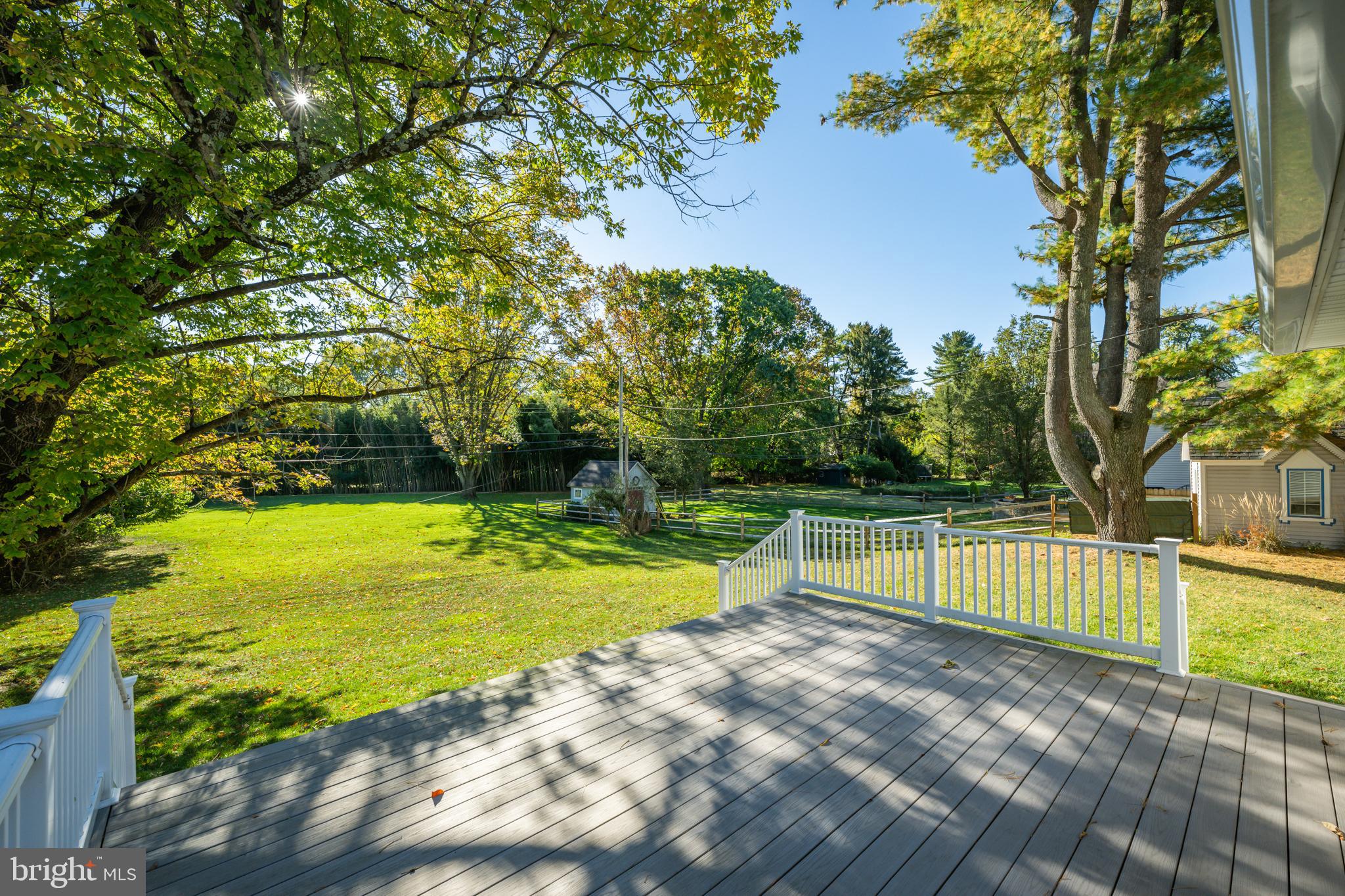 312 East Mill Road Flourtown, PA 19031 - Photo 7 of 36 a view of a swimming pool with a yard and large trees
