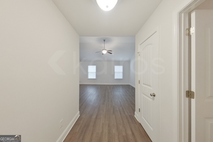 231 Western Red Cedar Drive Springfield, GA 31329 - Photo 2 of 26 a view of a hallway with wooden floor and a chandelier