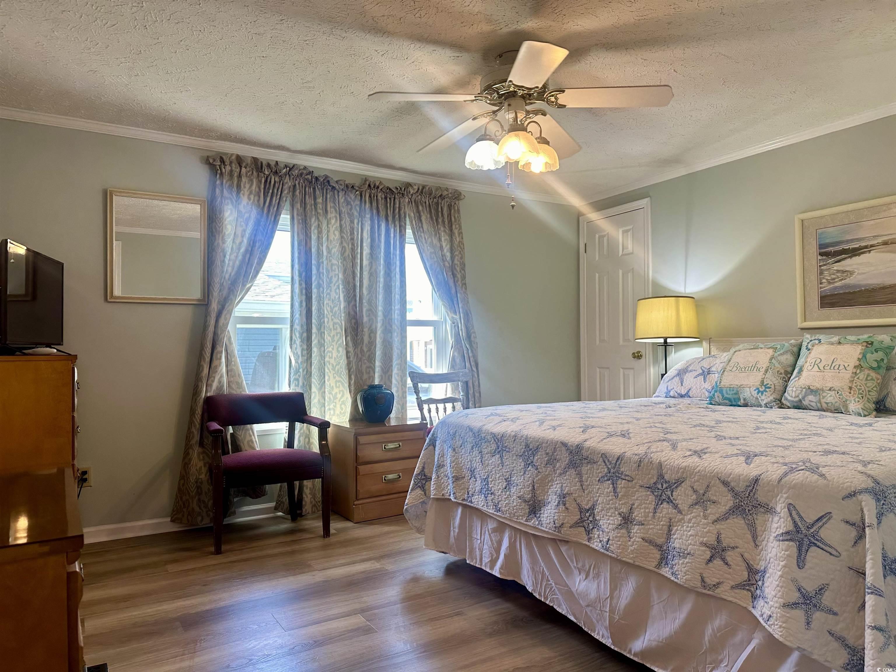 459 Meadowlark Surfside Beach, SC 29575 - Photo 24 of 36 Bedroom featuring ceiling fan, crown molding, hard