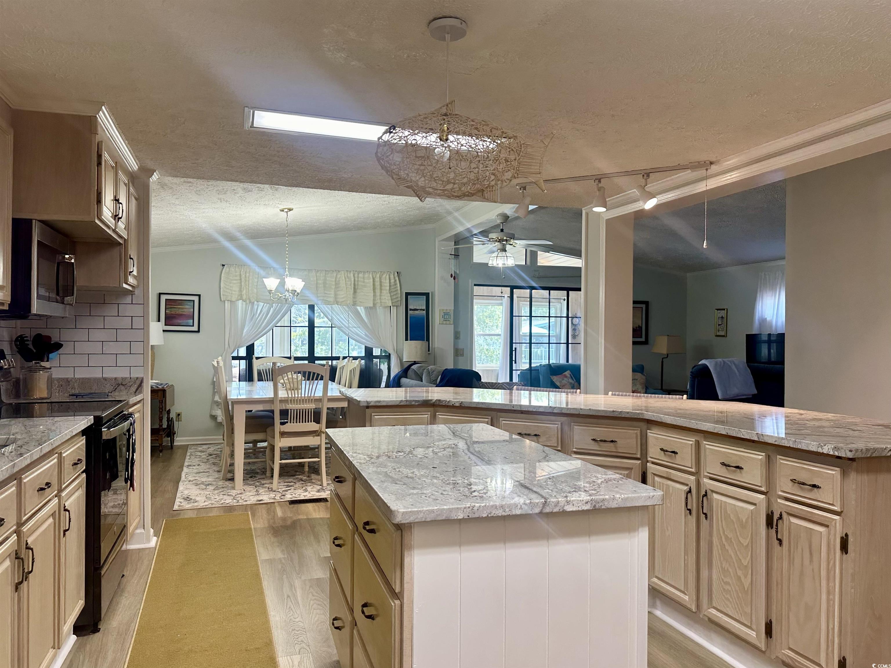Kitchen featuring a center island, light wood-type