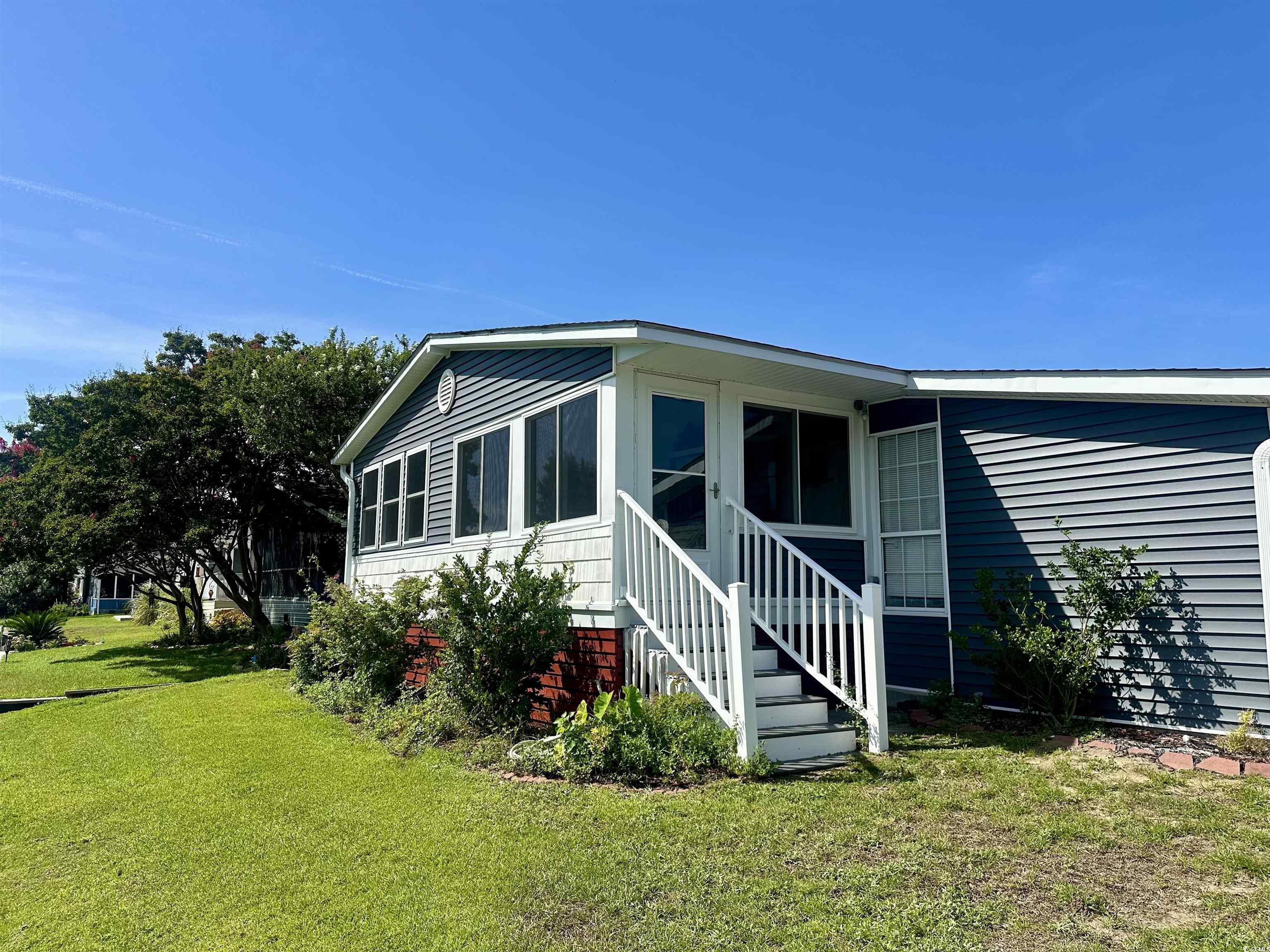 459 Meadowlark Surfside Beach, SC 29575 - Photo 32 of 36 Exterior space featuring a lawn