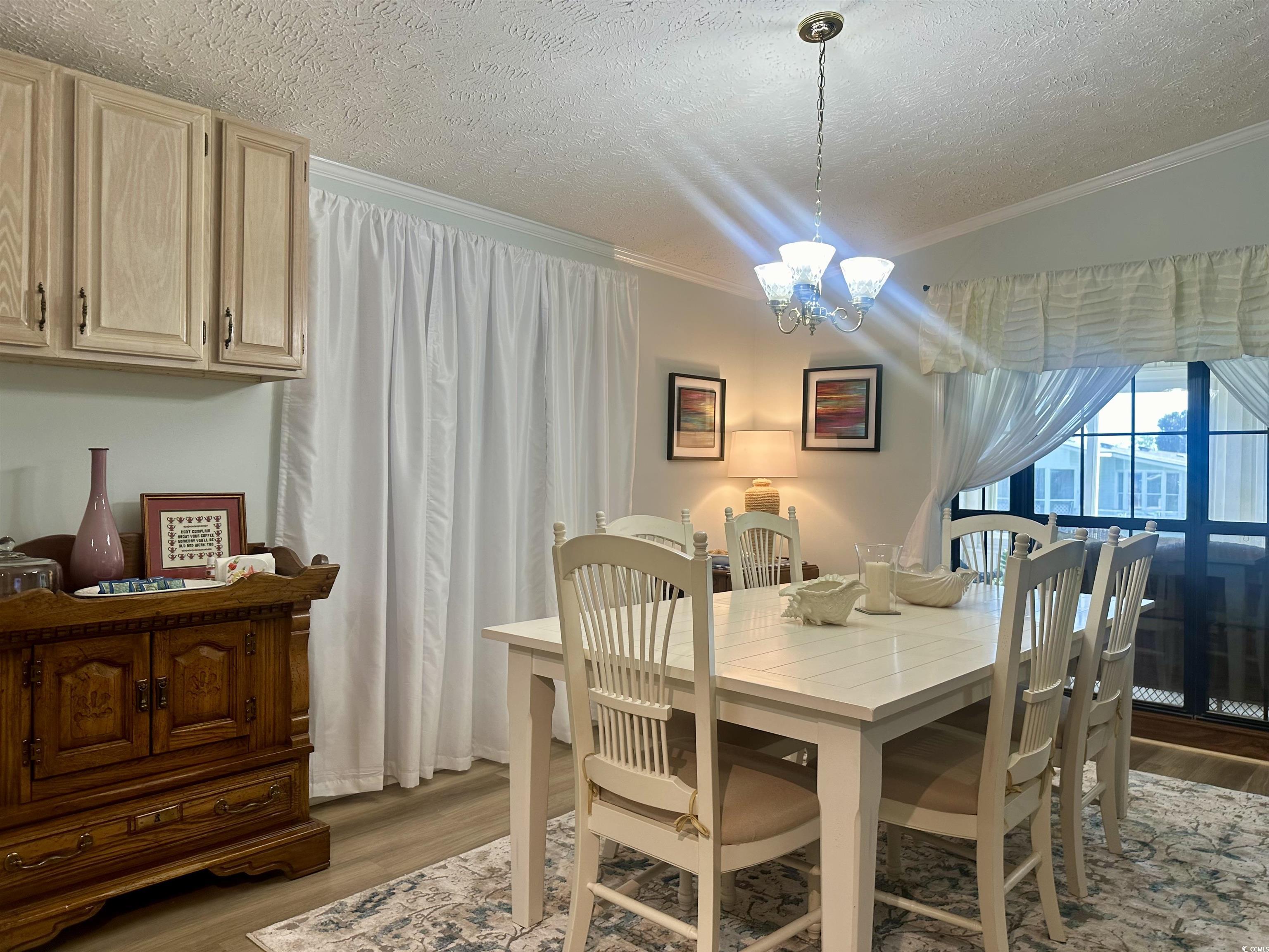 Dining room featuring a notable chandelier, crown