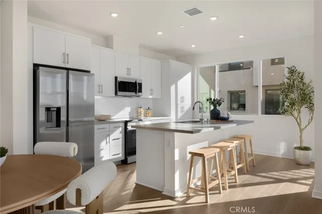 a kitchen with stainless steel appliances kitchen island granite countertop a sink and cabinets