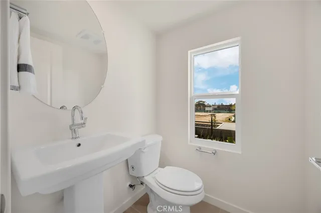 a bedroom with a bed tv and a window