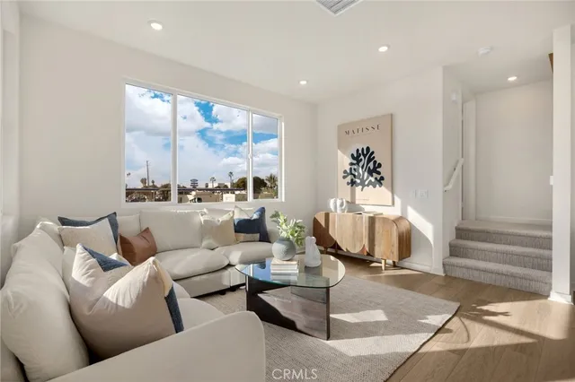 a view of a dining room with furniture a rug and wooden floor