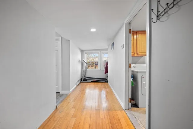 a view of gallery with wooden floor