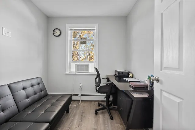 a view of a workspace with furniture and a window