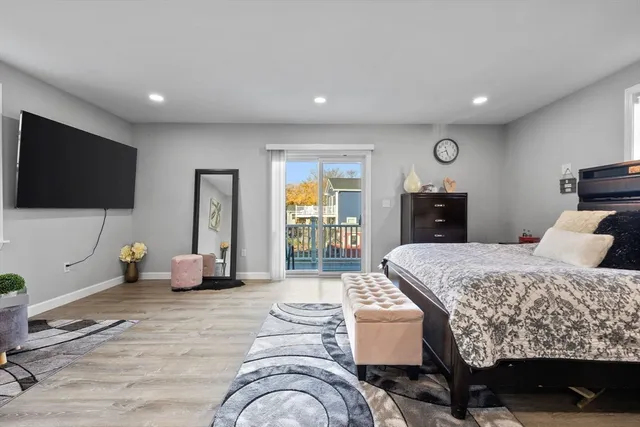 a bedroom with furniture and a flat screen tv