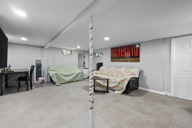 a spacious bedroom with a bed and a view of kitchen