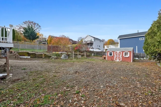 a view of a large house with a yard and a large tree