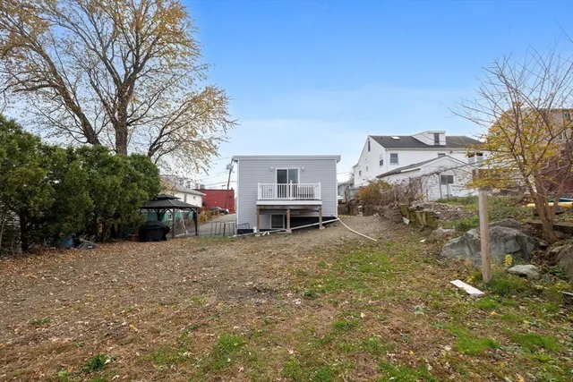 a view of backyard with a table and chairs and potted plants